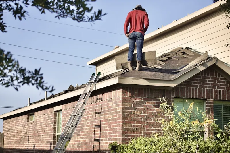 Professional roofer working on a residential roof in Englewood Gardens North